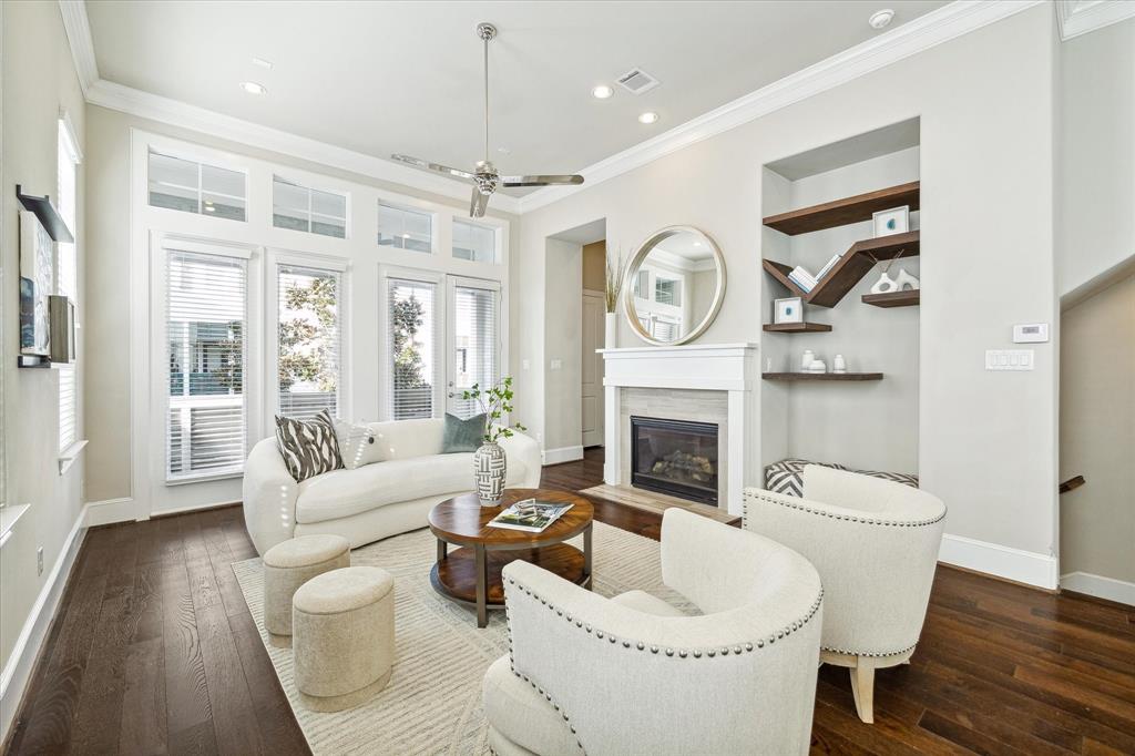 a living room with furniture a clock and a fireplace