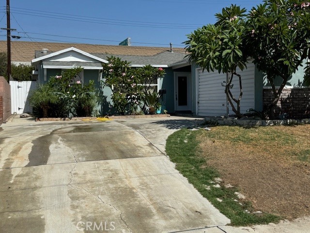 a front view of a house with yard and trees