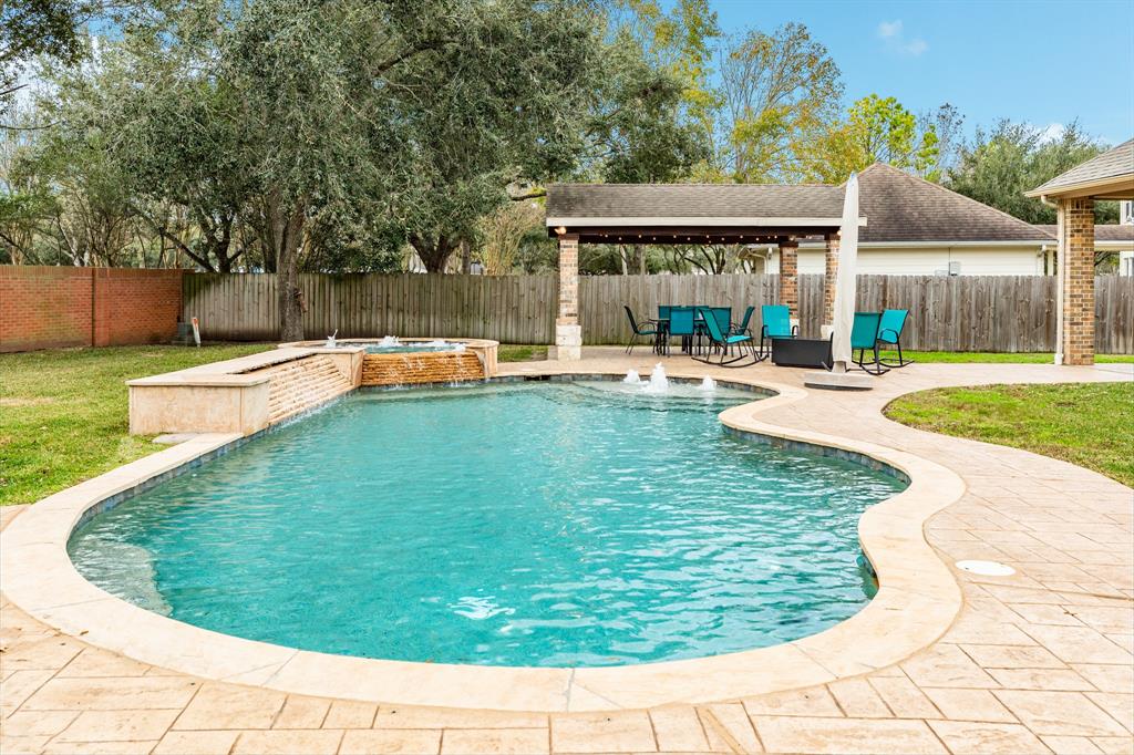 Spacious backyard oasis is just waiting for your family to relax or host those weekend barbeques. Pool is designed with pebble tec coating for easy maintenance, waterfall accent and jetted spa. Relax under your covered cabana while watching an impromtu game of soccer or football!