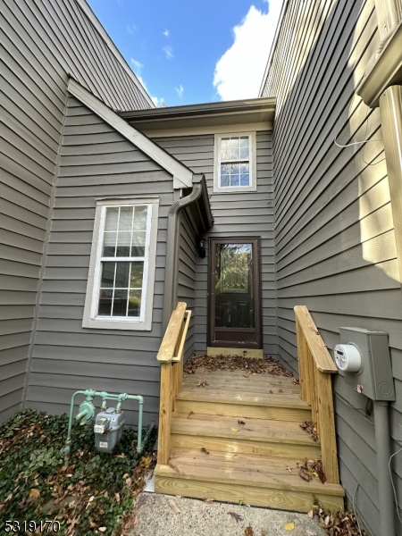 a view of house with wooden door and outdoor seating