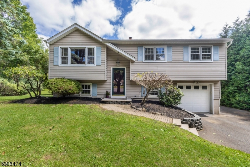 a front view of house with yard and outdoor seating