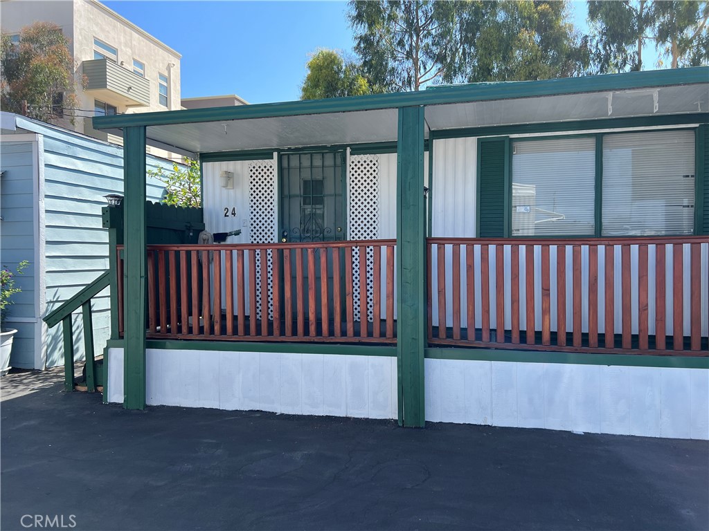 a view of a house with a wooden fence