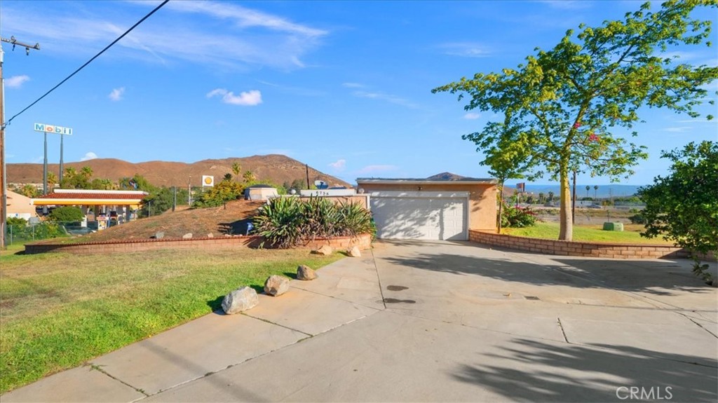 a view of a house with a yard and a street view