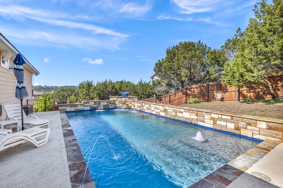 a view of a swimming pool with lounge chair