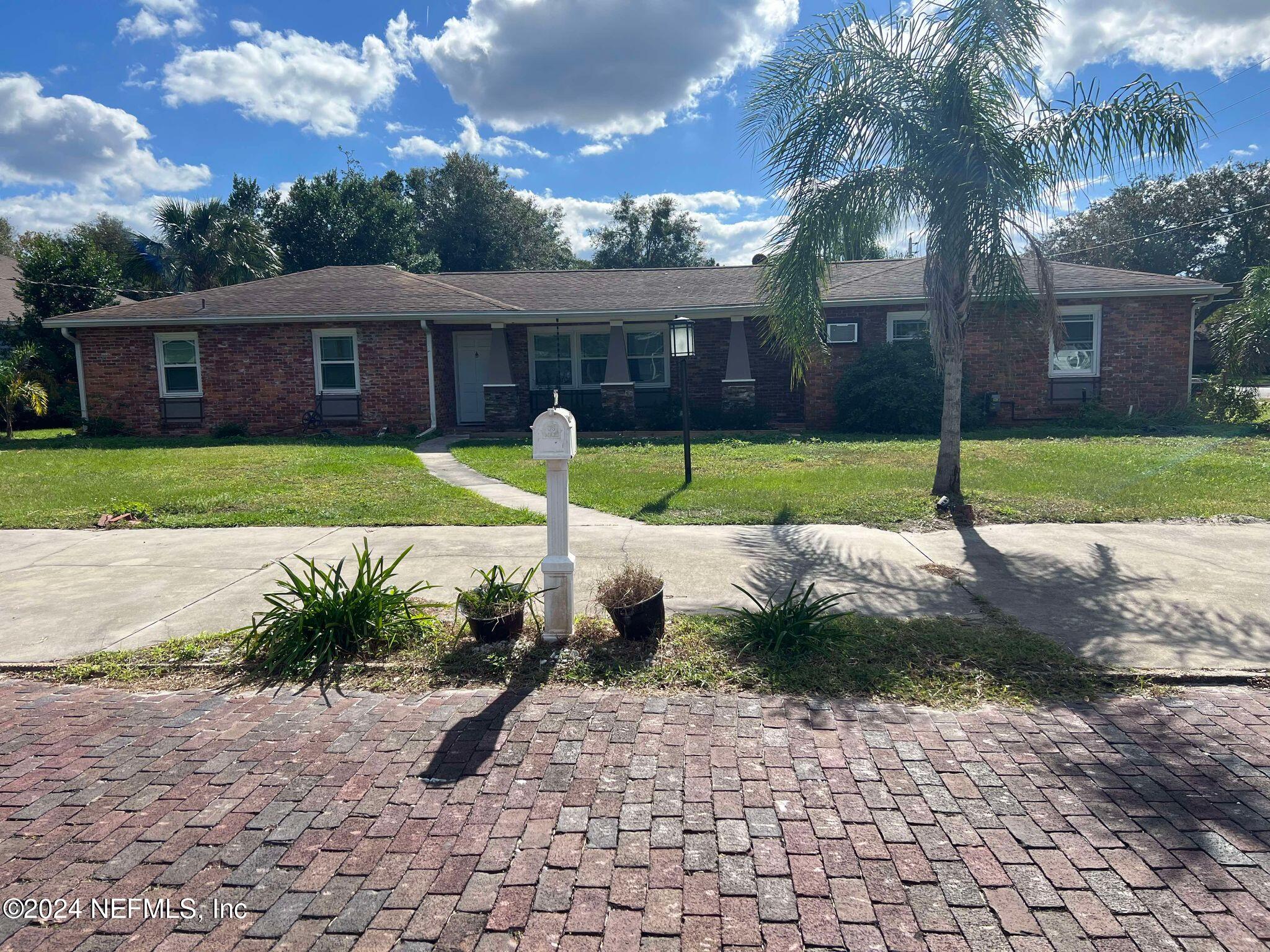 a view of a house with a backyard