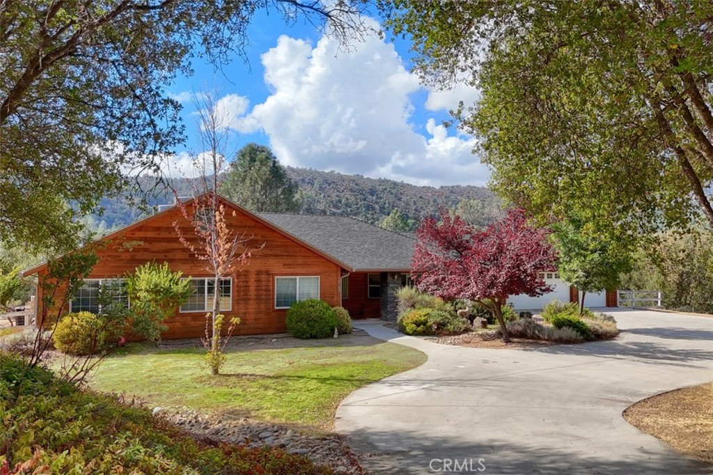 a front view of a house with a yard garage and outdoor seating