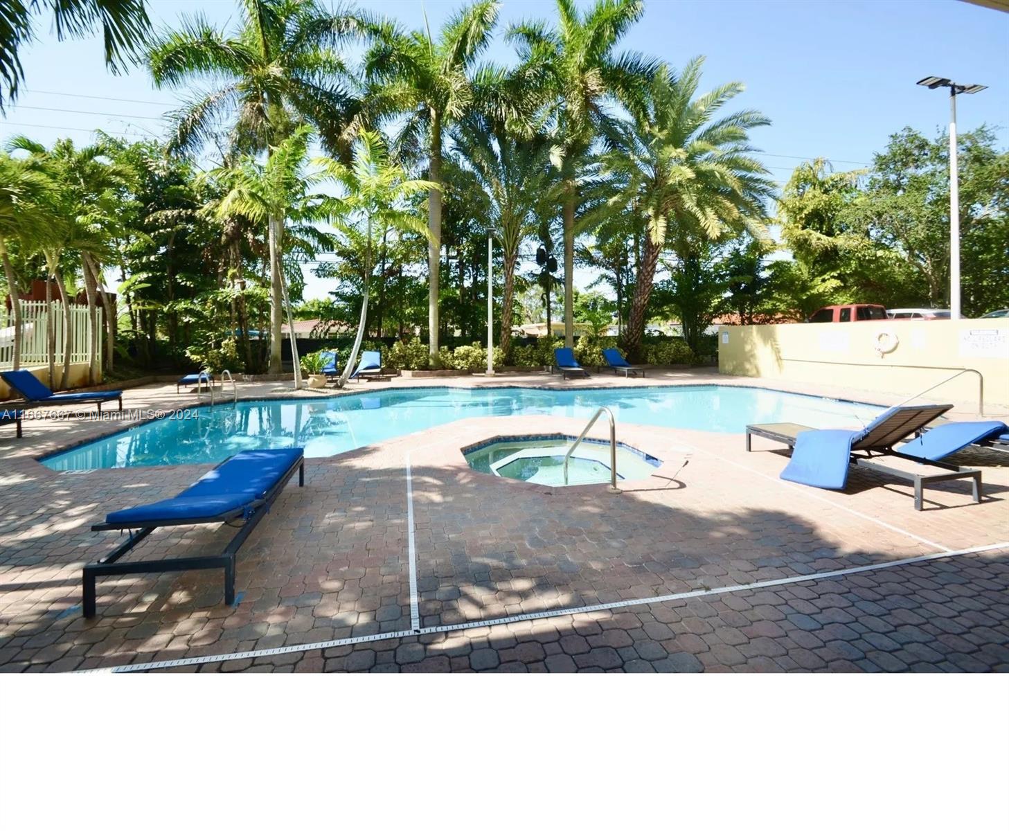 a view of a swimming pool with a yard