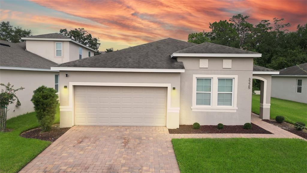 a front view of a house with a yard and garage