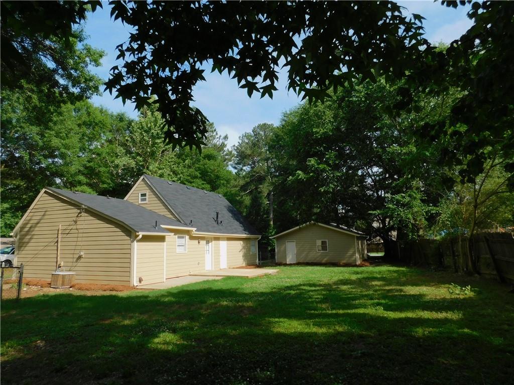 a front view of house with a garden