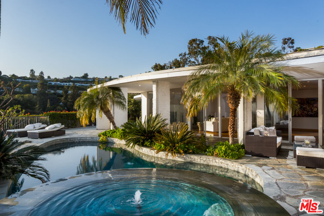 a view of a palm tree with dinning table and chair in the patio