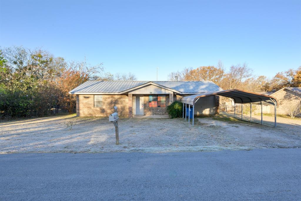 a view of a house with a yard and sitting area