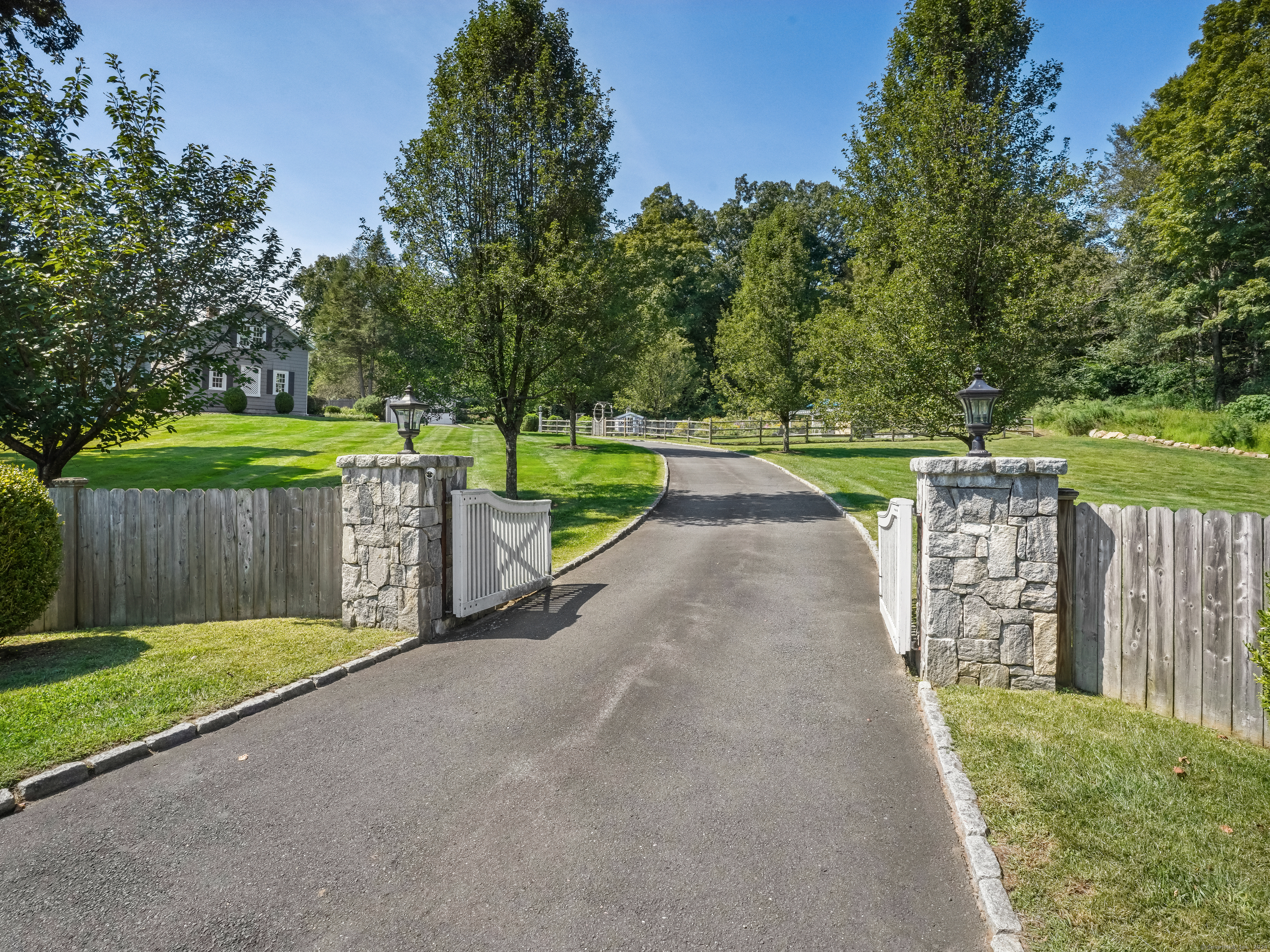 a view of a garden with wooden fence