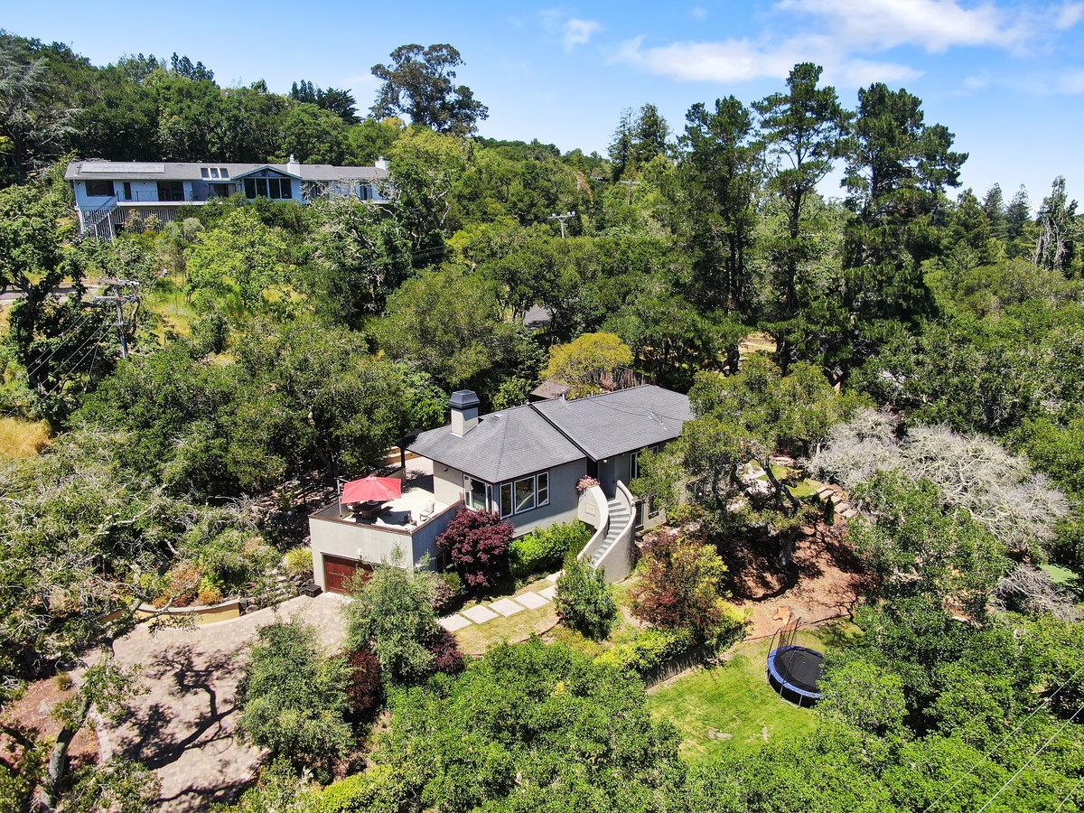 an aerial view of a house with yard swimming pool and outdoor seating