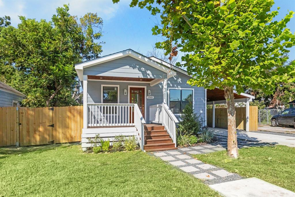 Charming single-story Craftsman-style bungalow, exuding warmth and curb appeal.