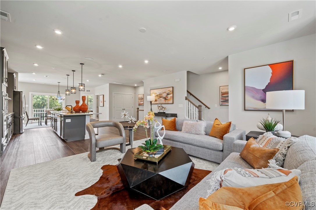 a living room with furniture and a view of kitchen