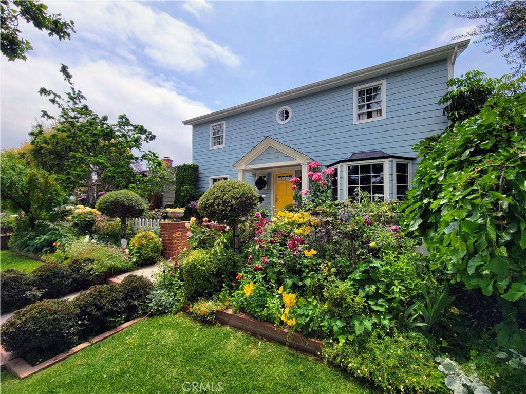 a front view of house with a garden