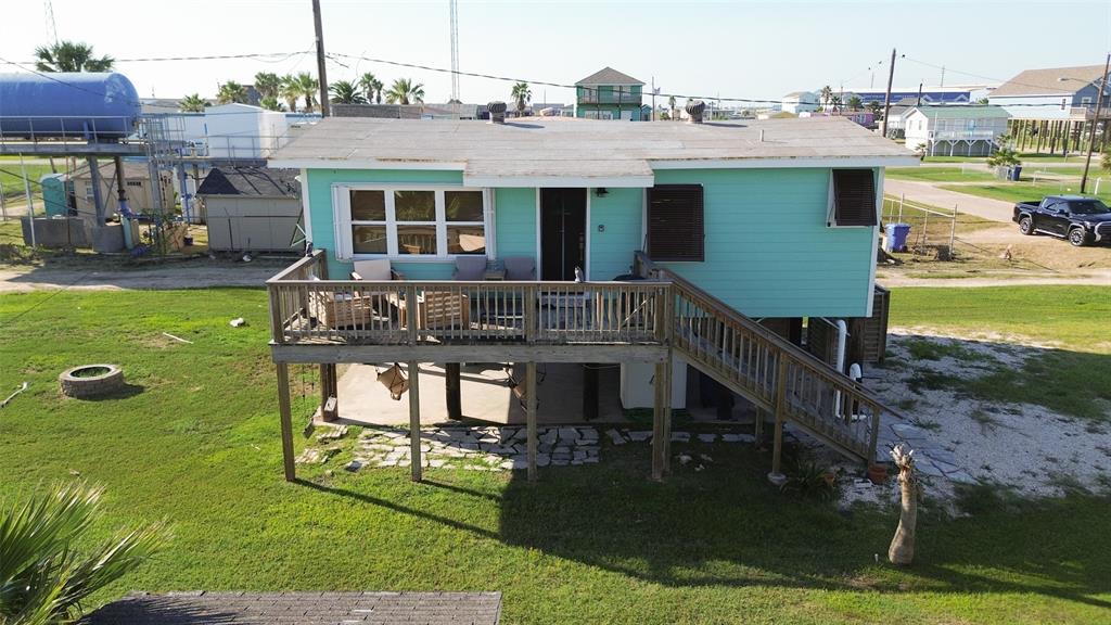 a aerial view of a house with swimming pool having outdoor seating