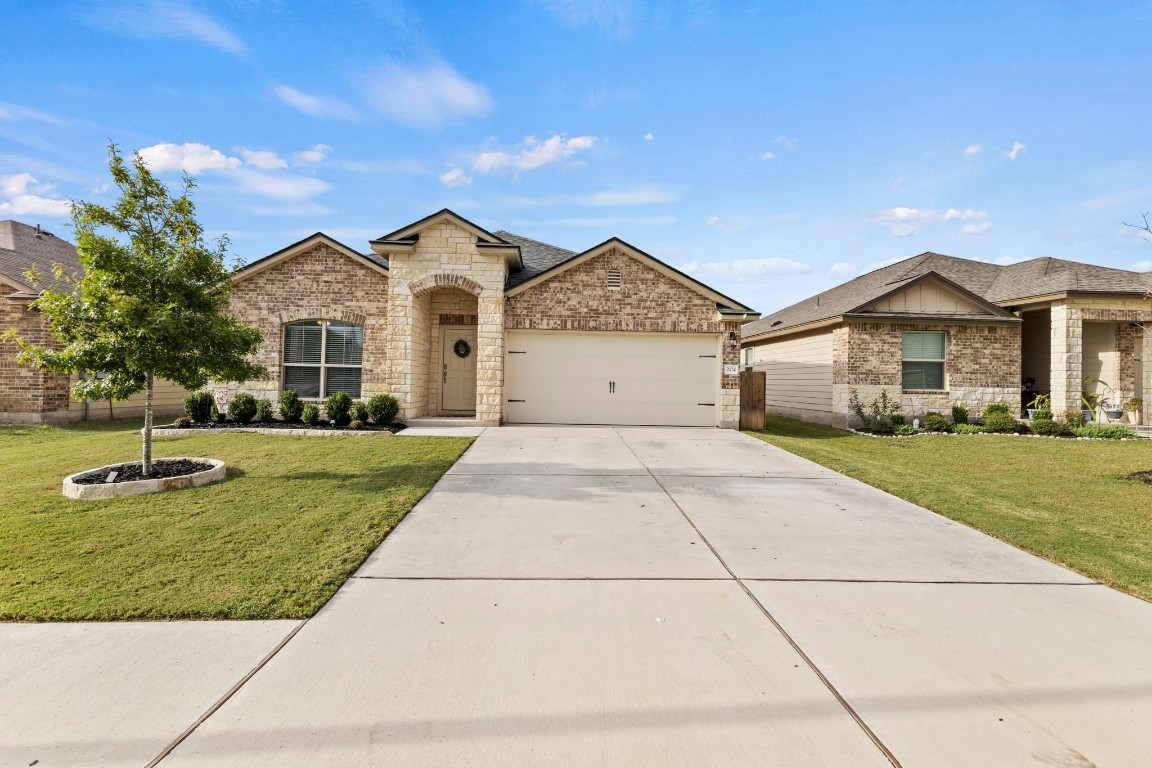 a front view of a house with a yard