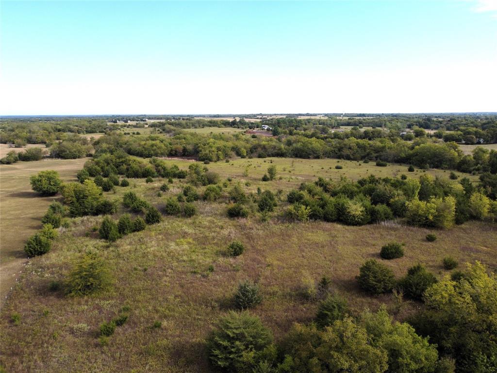 an aerial view of mountains with green space