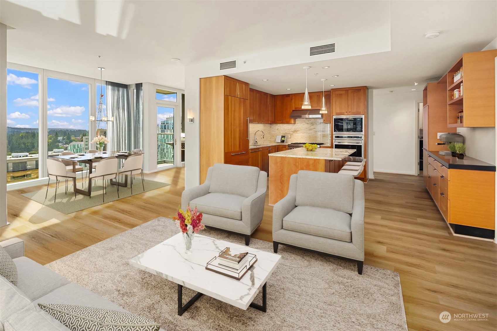 a living room with furniture kitchen view and a large window