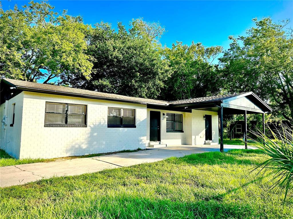 a front view of house with yard and green space