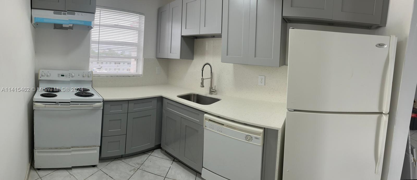 a kitchen with a refrigerator and a sink