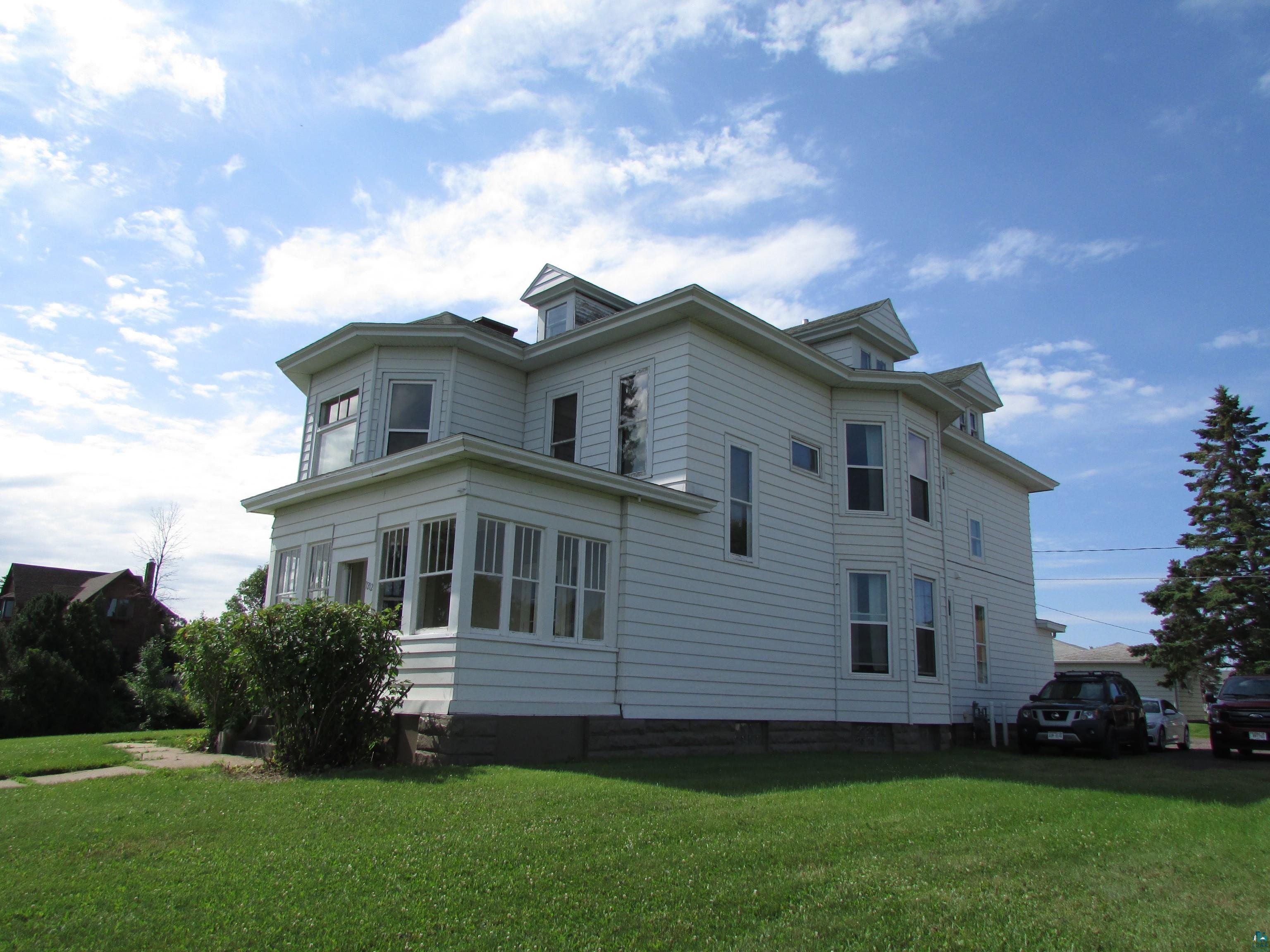 View of side of property featuring a yard