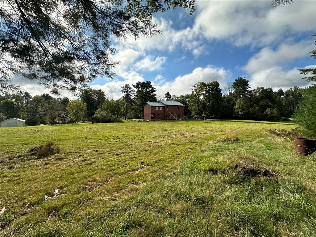 a view of a green field with wooden fence