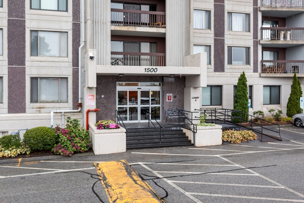 a front view of a building and car parked