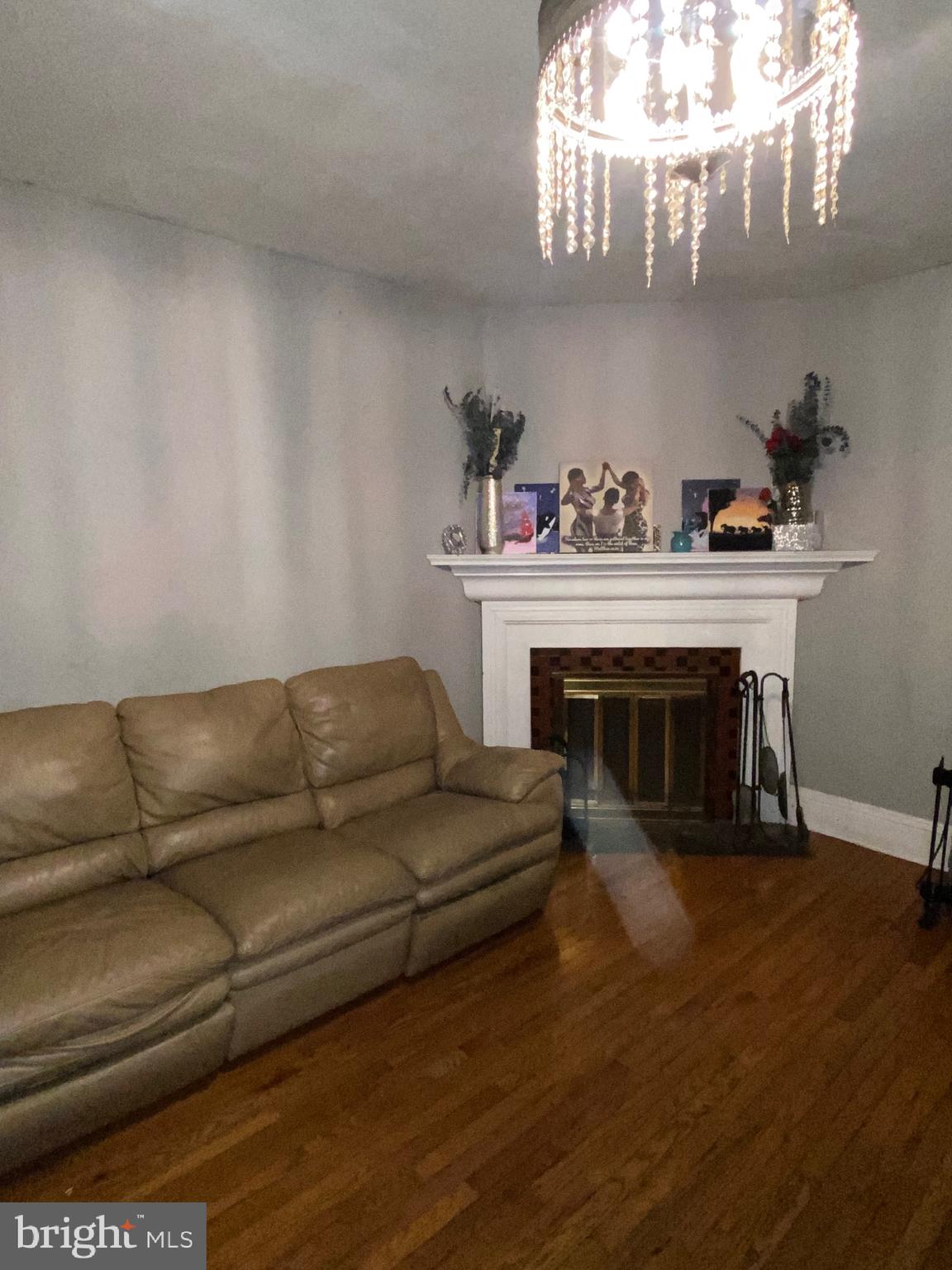 a living room with furniture a fireplace and chandelier