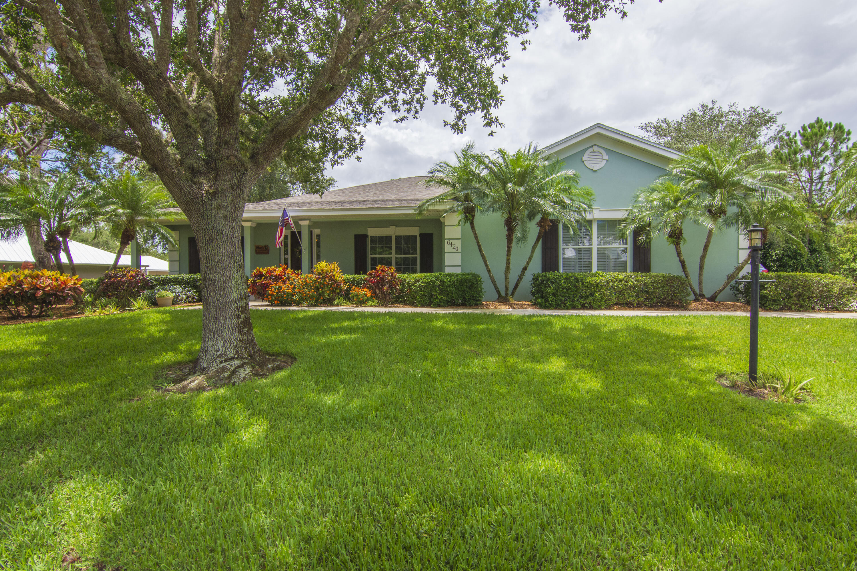 a front view of house with yard and green space