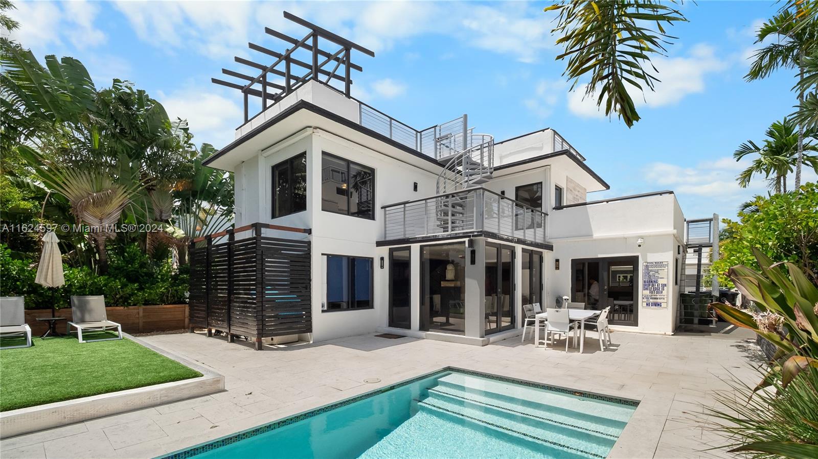 a view of a house with backyard porch and sitting area