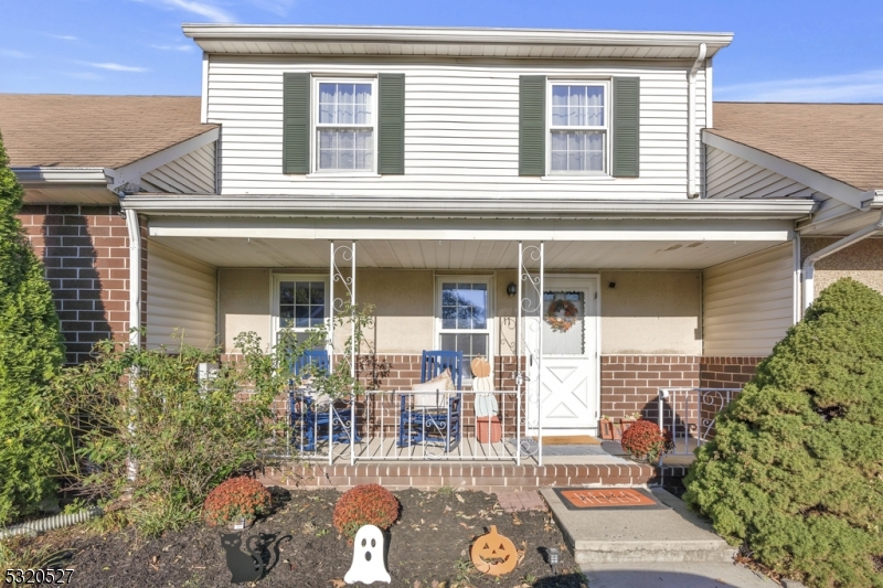 front view of a house with a chairs