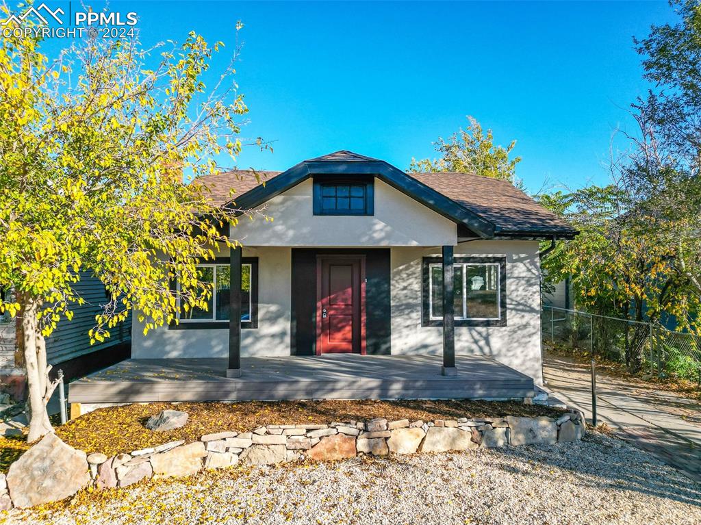 View of front of house with a wooden deck