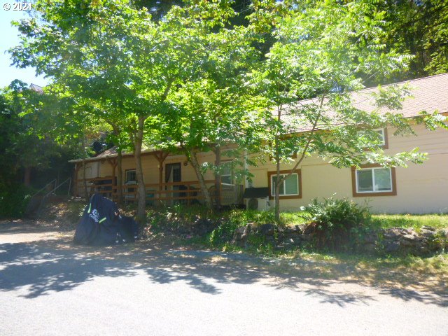 a front view of a house with a yard and tree s