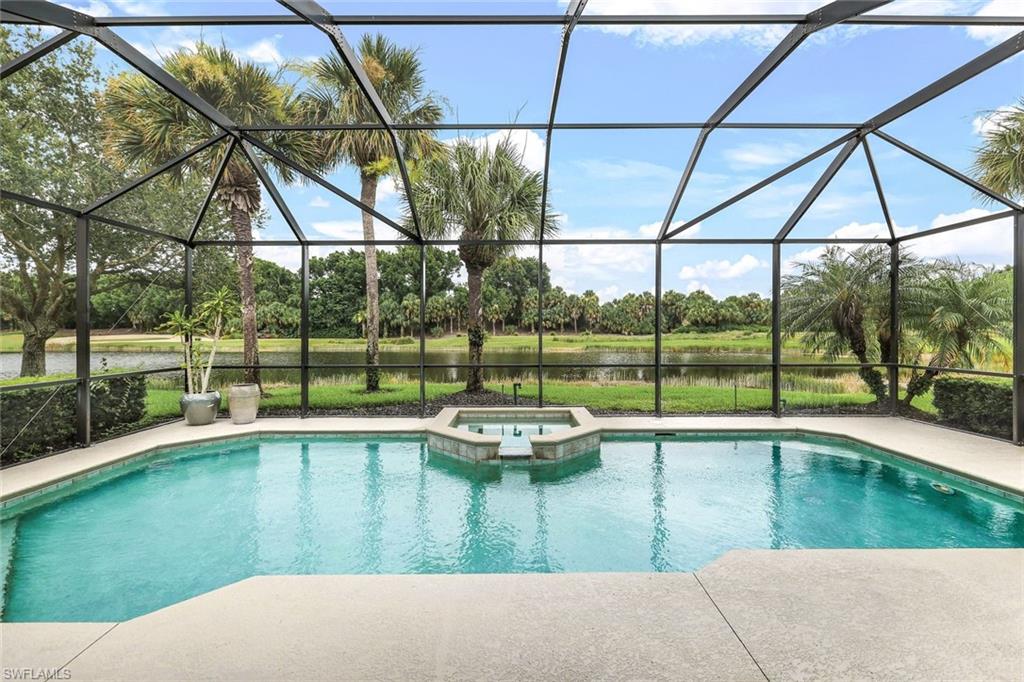 View of pool featuring an in ground hot tub and a lanai