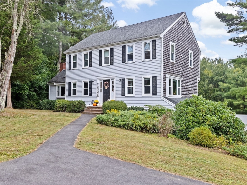 a front view of a house with a garden