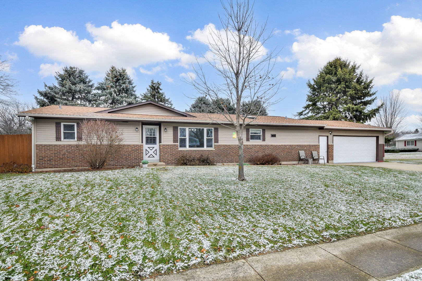 a house with green field in front of it