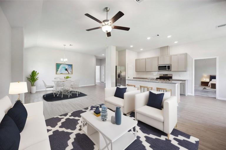 a living room with furniture and kitchen view