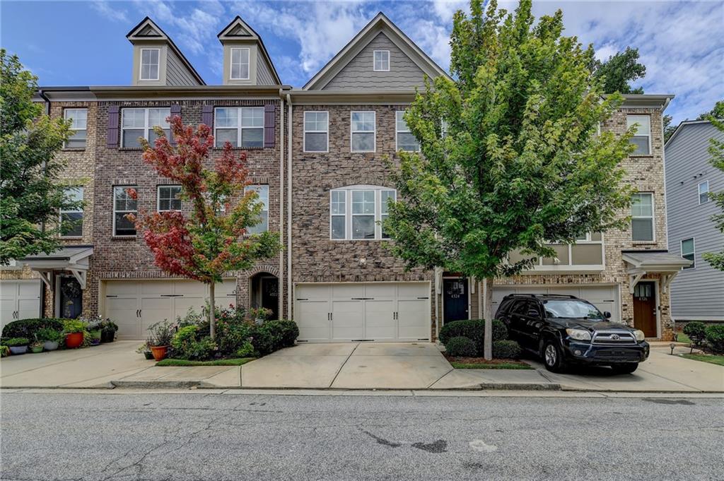 front view of house with a yard and car parked