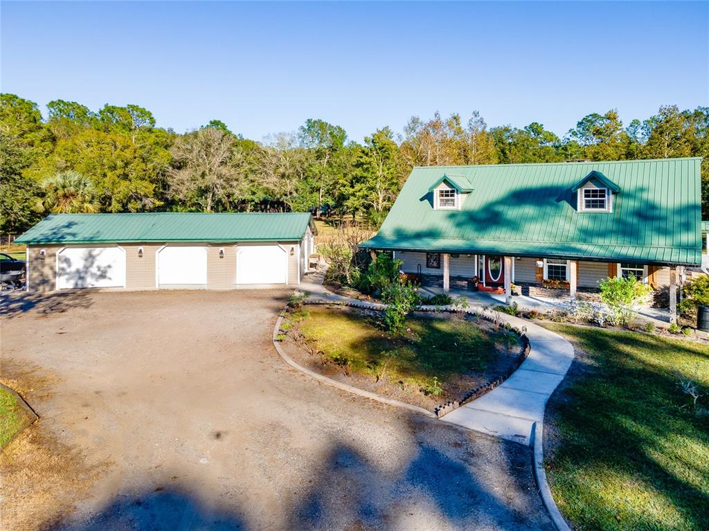 an aerial view of a house with swimming pool patio and outdoor seating