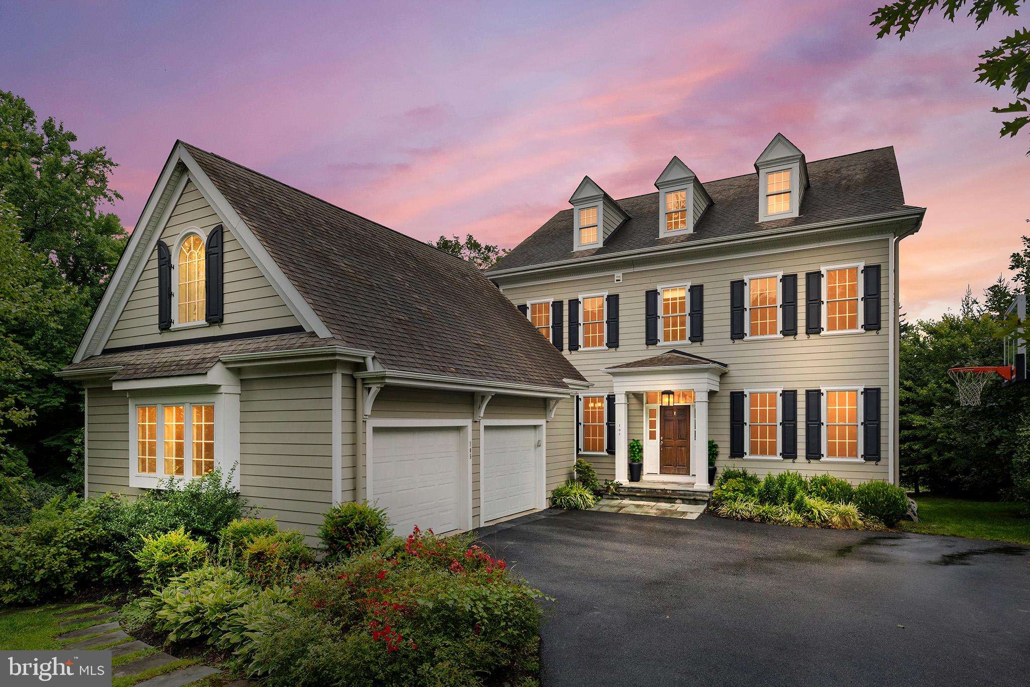 a front view of a house with yard and parking