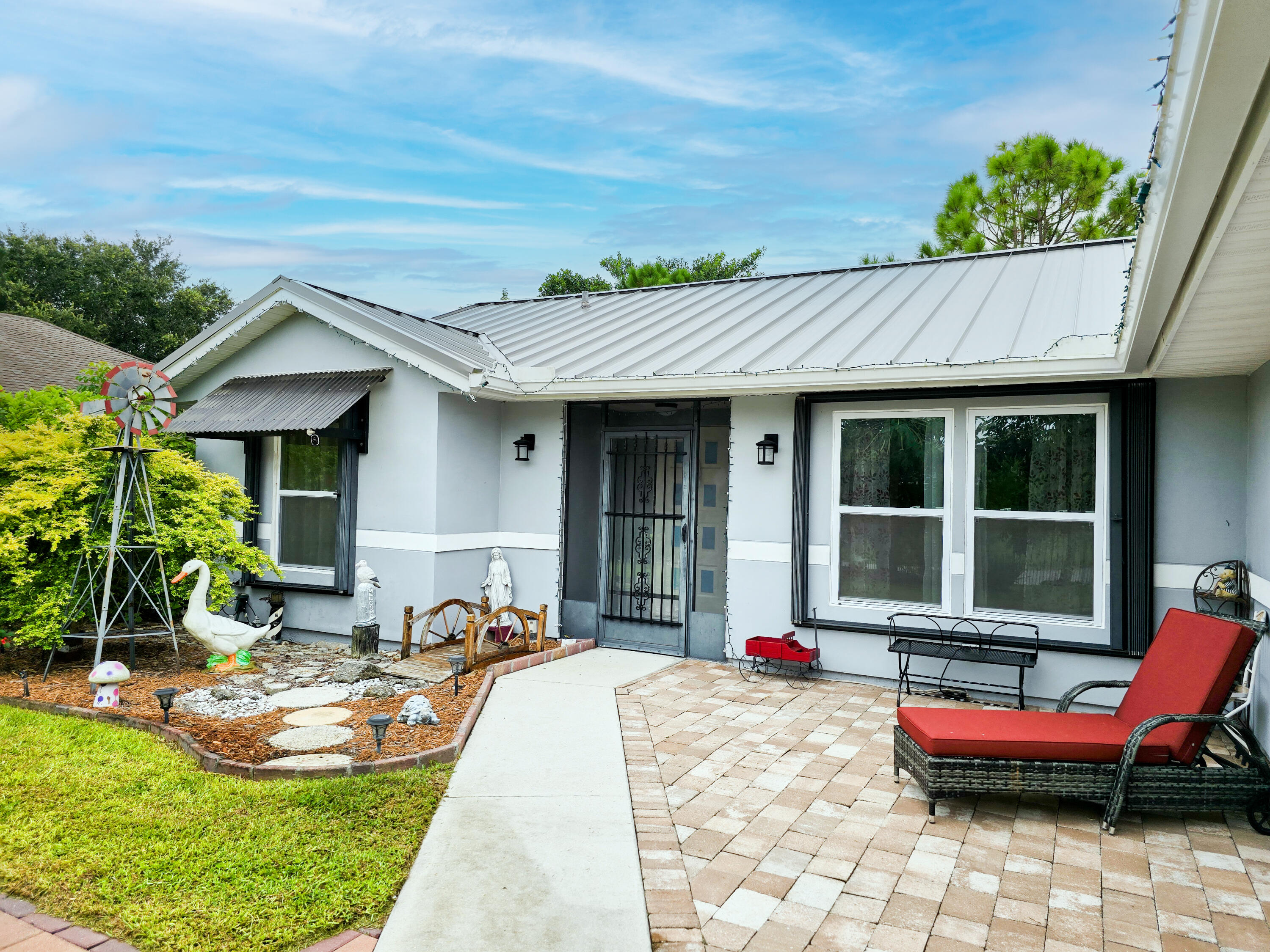 a view of a house with backyard sitting area and porch