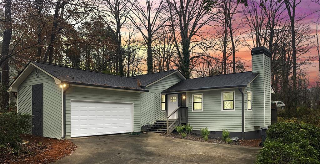 a view of a house with a yard and garage