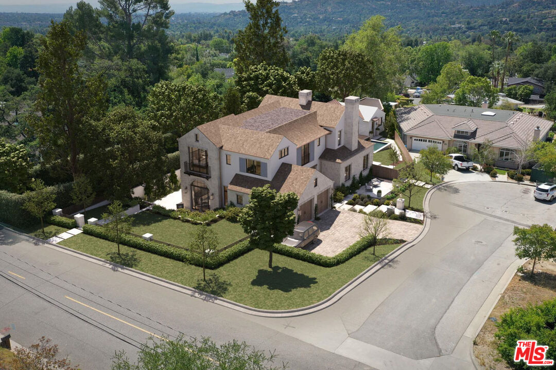 an aerial view of a house with outdoor seating