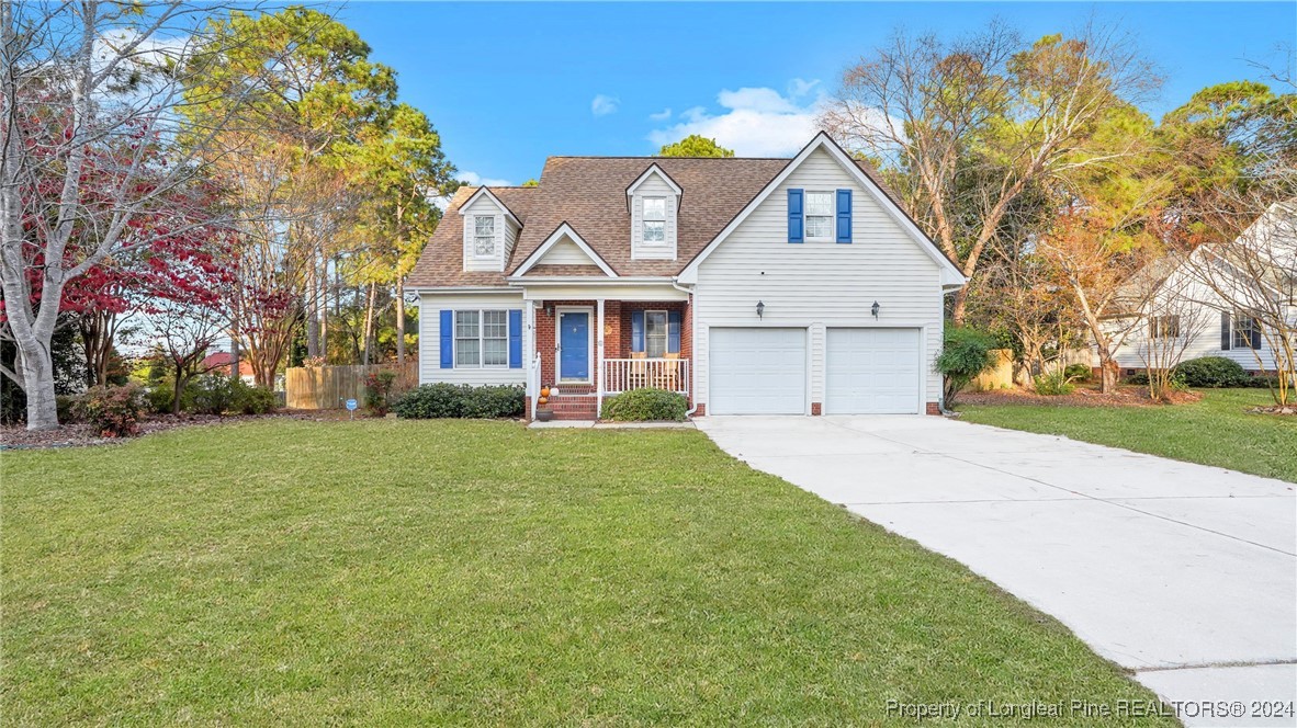 a front view of a house with a garden and trees