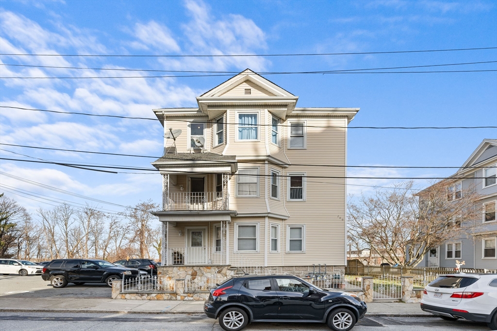 a front view of a building with parking space