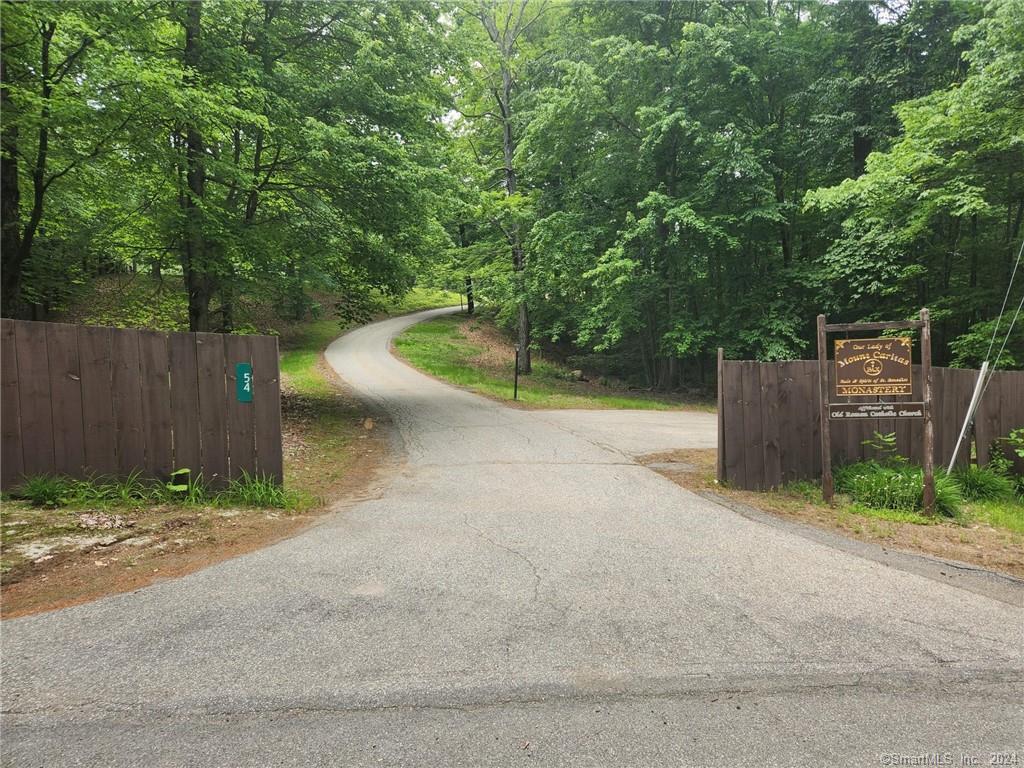 a view of a wooden fence and trees