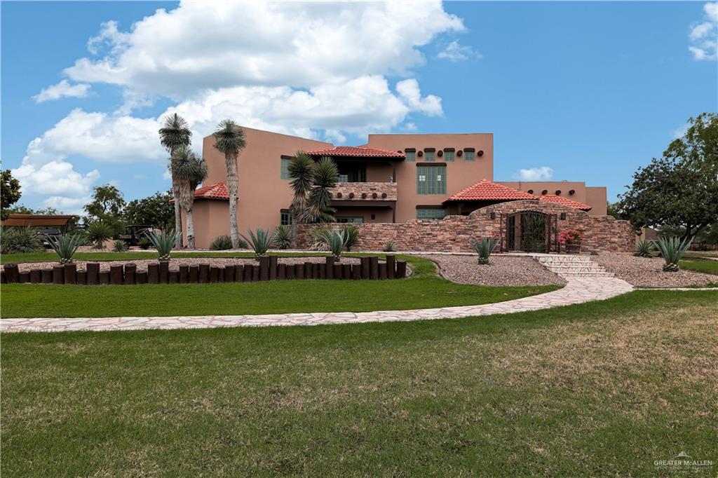 a view of a house with a swimming pool and a yard