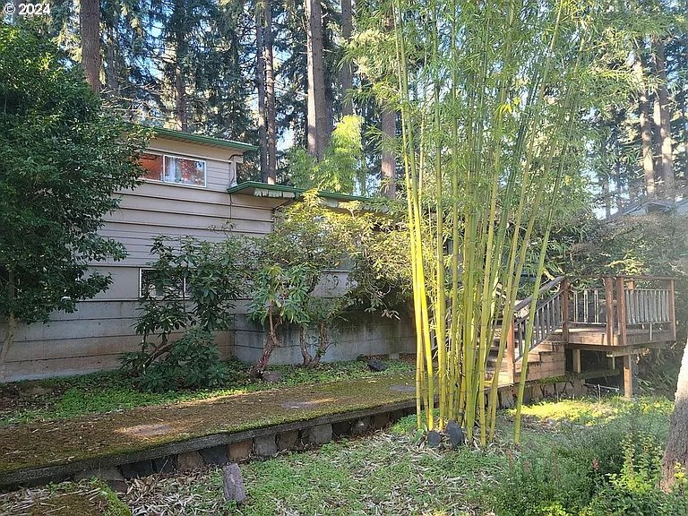 a backyard of a house with lots of green space and fountain